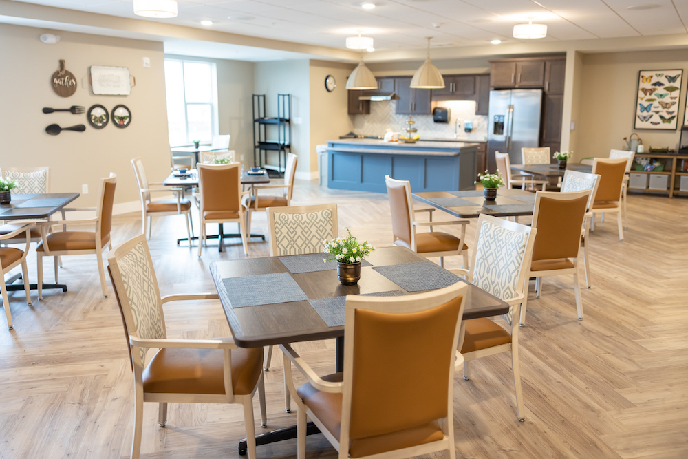 Bright, spacious dining area with modern decor and cozy seating arrangements near a kitchen.