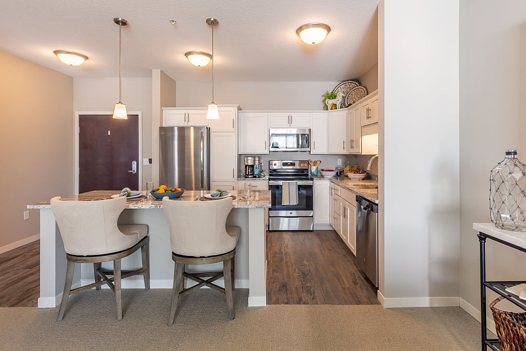 Large kitchen with island and barstools.