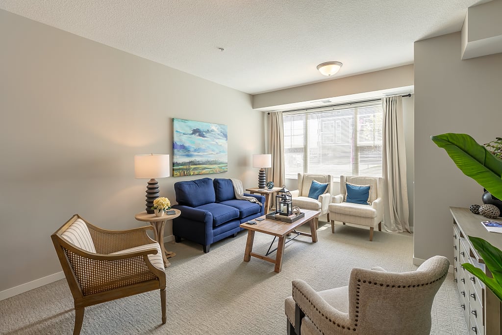 Cozy living area with couches, armchairs, and tables.